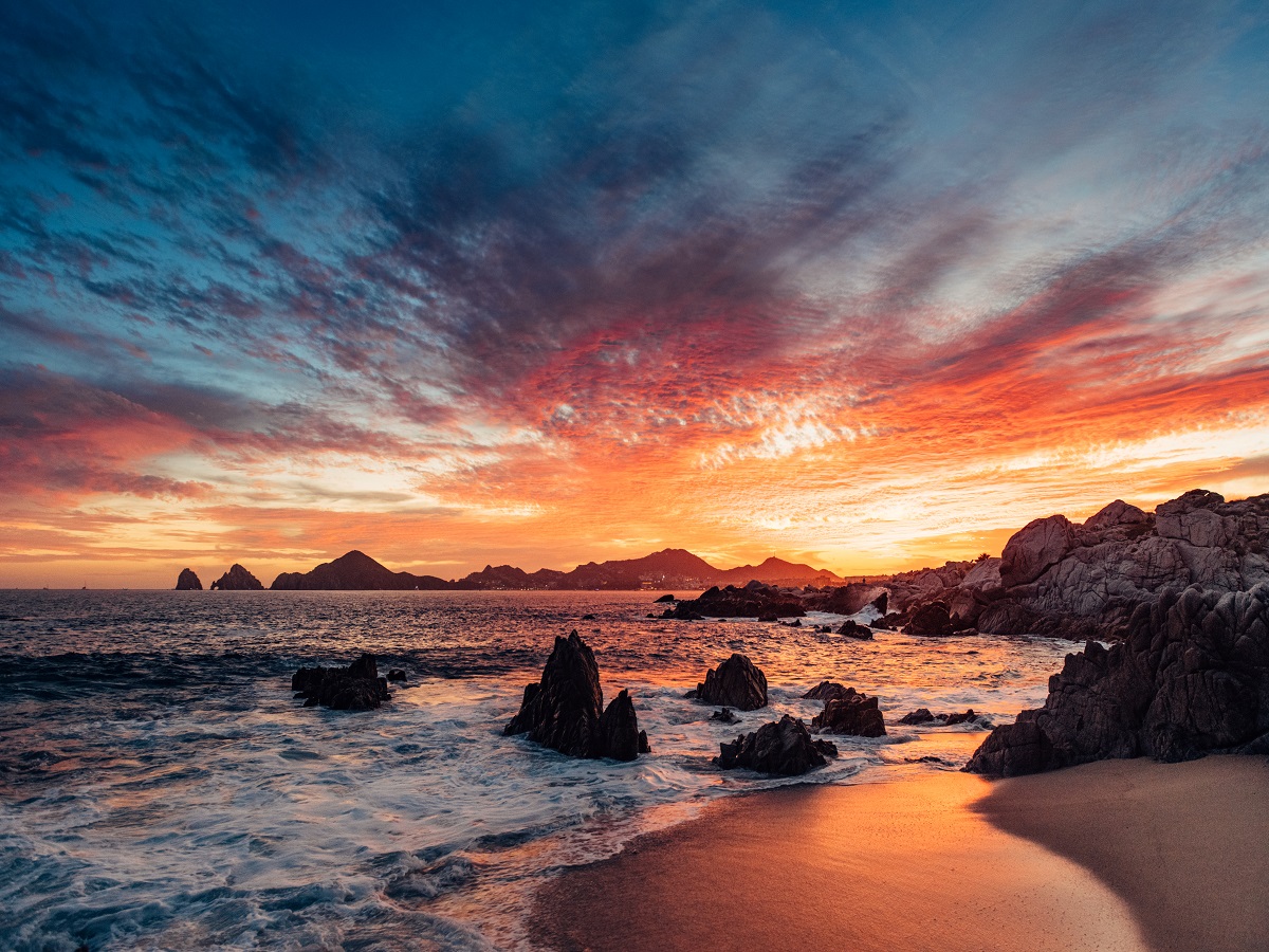 1141277826 Dramatic sunset in Cabo San Lucas with the view of Lands End at the horizon, Mexico.
