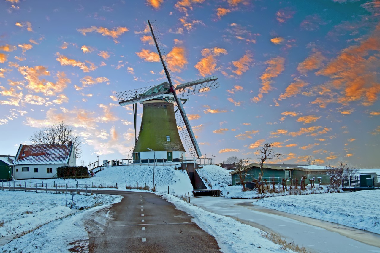 Traditional windmill in the countryside from the Netherlands in winter at sunset