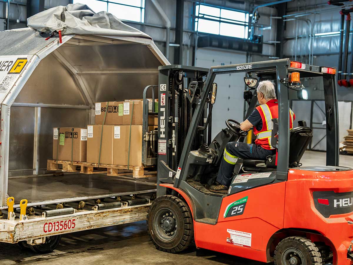Cargo Warehouse ULD Worker filling cargo container